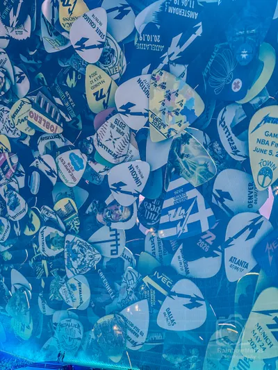Guitar picks from tours past cover the Sphere